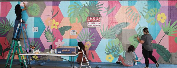 ART 141 students working on a mural project